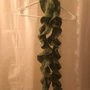 Twisted hand-crocheted scarf in moss green.